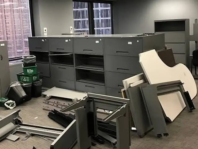 Disassembled cubicle panels and filing cabinets in an office